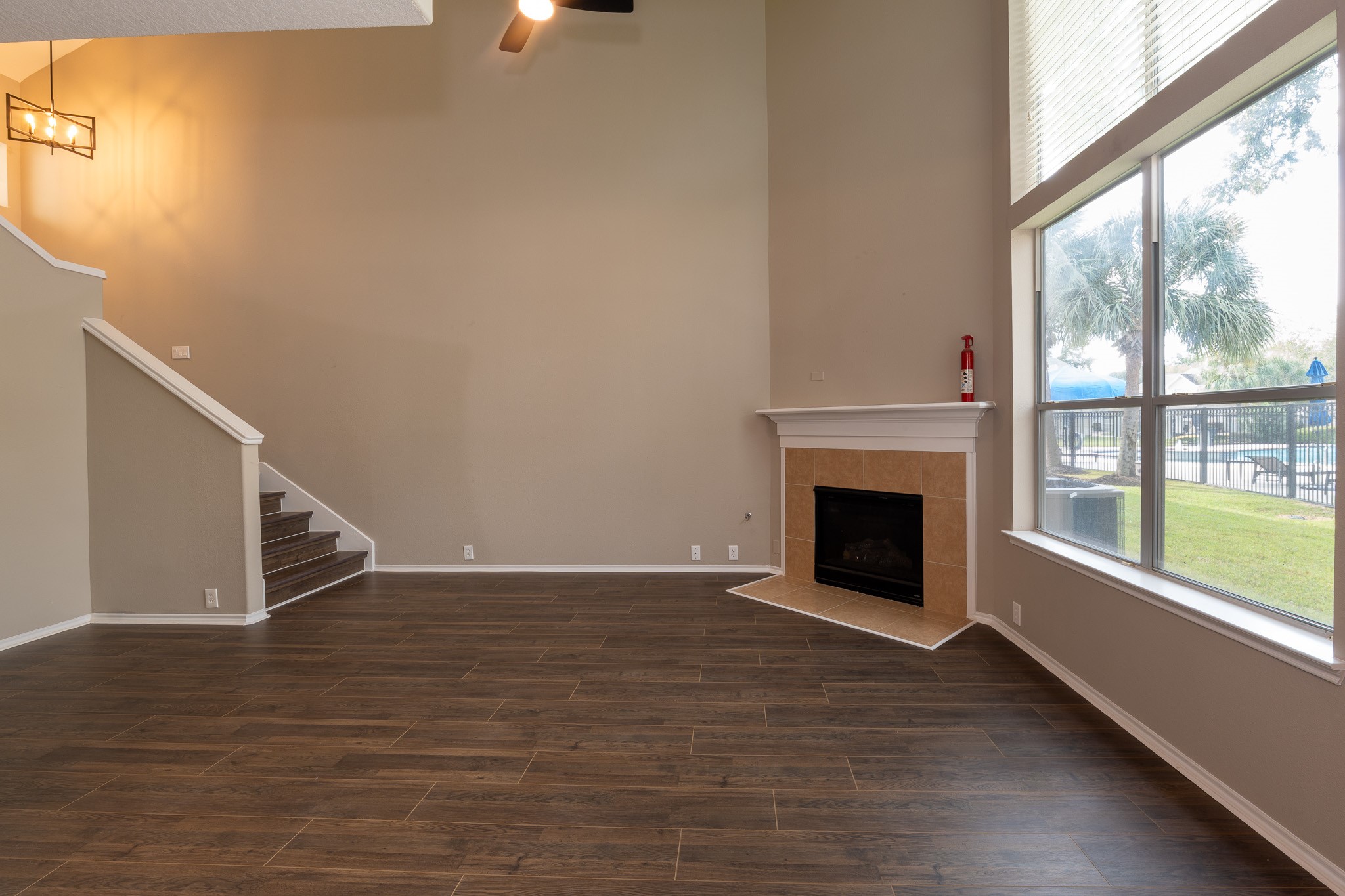 13600 Breton Ridge Street, Unit 35C Houston, TX 77070 - Photo 7 of 35 a view of an empty room with wooden floor fireplace and a window