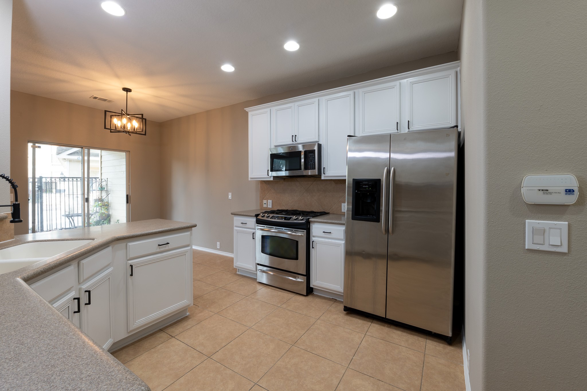 13600 Breton Ridge Street, Unit 35C Houston, TX 77070 - Photo 10 of 35 a kitchen with white cabinets and stainless steel appliances