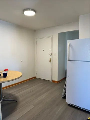a view of an empty room and wooden floor