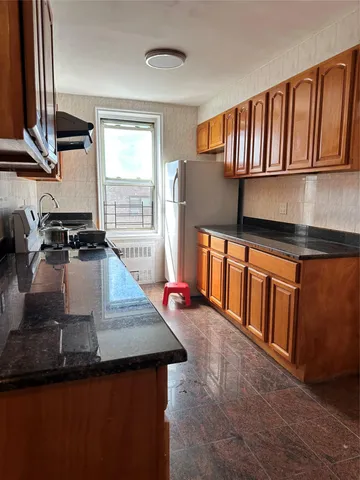 a kitchen with stainless steel appliances granite countertop a sink wooden cabinets and a granite counter tops