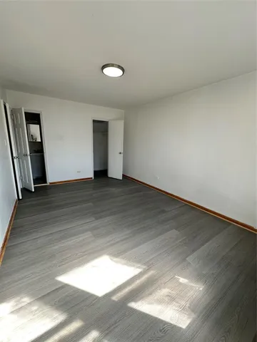 a view of an empty room and wooden floor