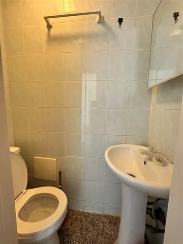 a bathroom with a sink a toilet and a mirror