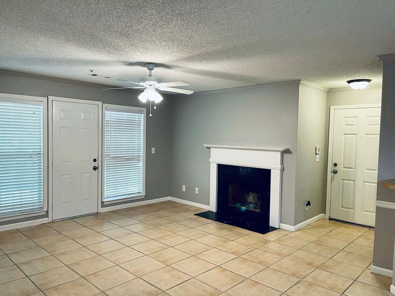 an empty room with fireplace and window
