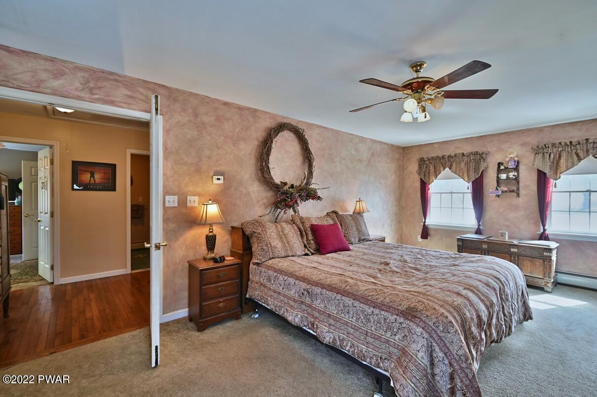 183 Valleyview Road Greentown, PA 18426 - Photo 58 of 110 a bedroom with a bed and a chandelier