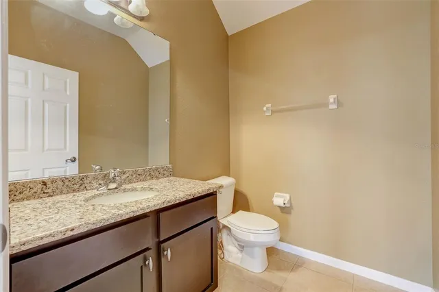 an empty room with a window and a ceiling fan