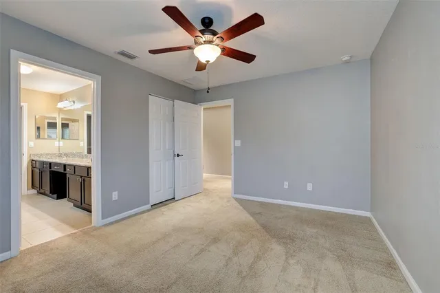 a bathroom with a granite countertop tub a sink and a large mirror