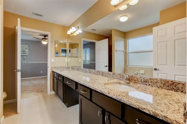 an empty room with closet and chandelier fan