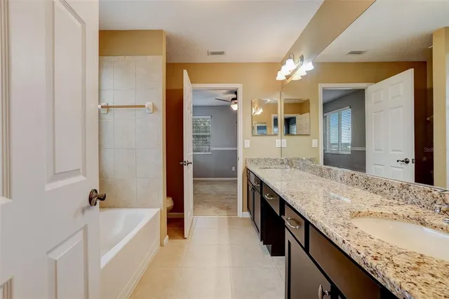 an empty room with closet and a ceiling fan