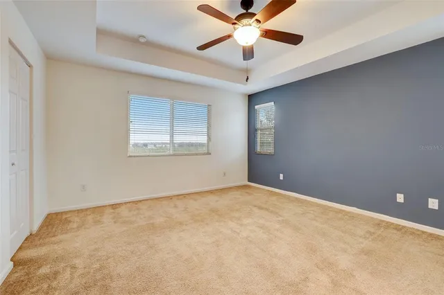 a bathroom with a granite countertop sink a mirror and a bathtub