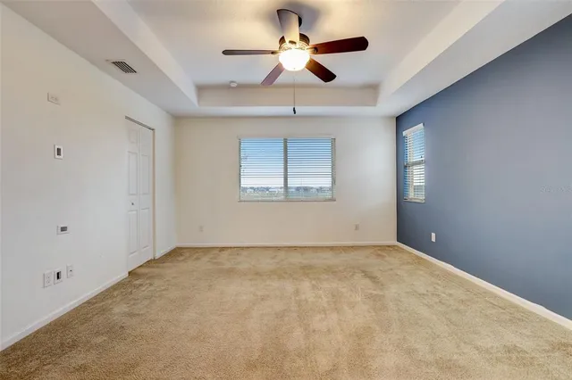 a view of a house with a big yard and large tree