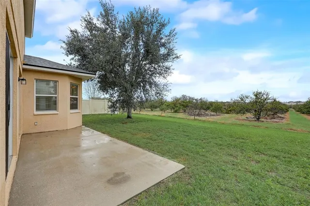 an aerial view of a house with a garden and lake view