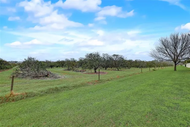 an aerial view of residential houses with outdoor space and lake view