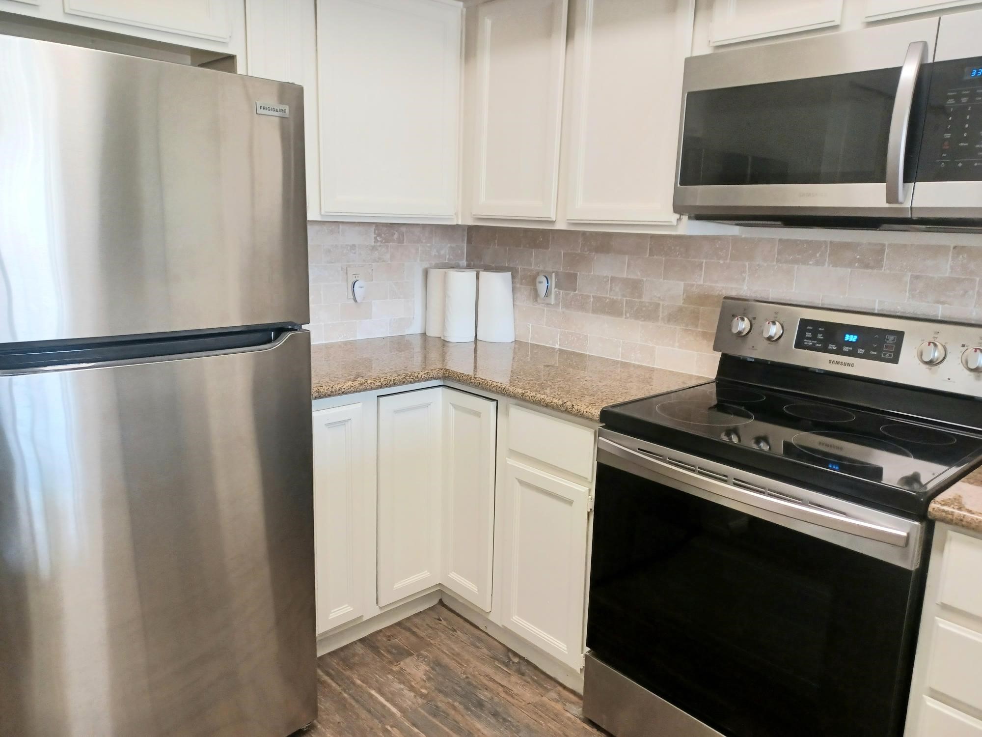 128 April Point Drive South Conroe, TX 77356 - Photo 9 of 26 a kitchen with a refrigerator stove and microwave