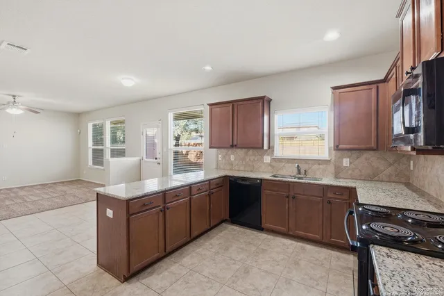 a kitchen with sink and cabinets