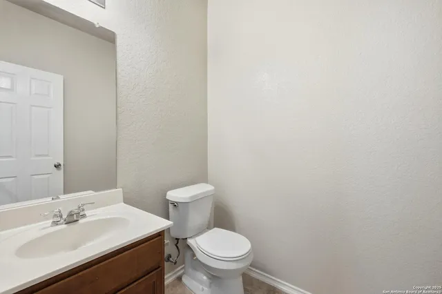a white toilet sitting next to a bathroom sink