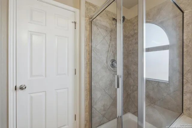 a bathroom with a glass shower door