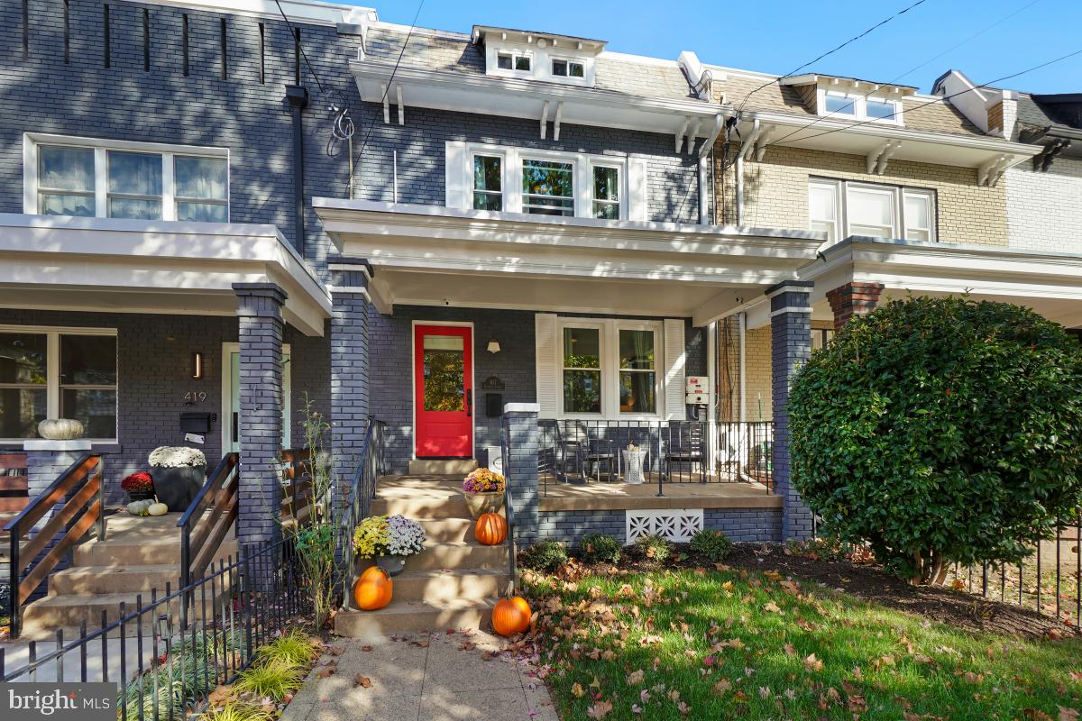 417 Emerson Street Northwest Washington, DC 20011 - Photo 2 of 47 front view of a house with a large window and potted plants