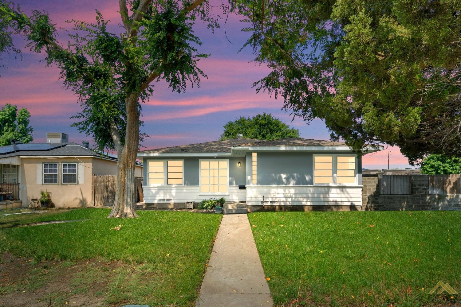 Undisclosed Address Bakersfield, CA 93301 - Photo 1 of 21 a front view of house with yard and green space