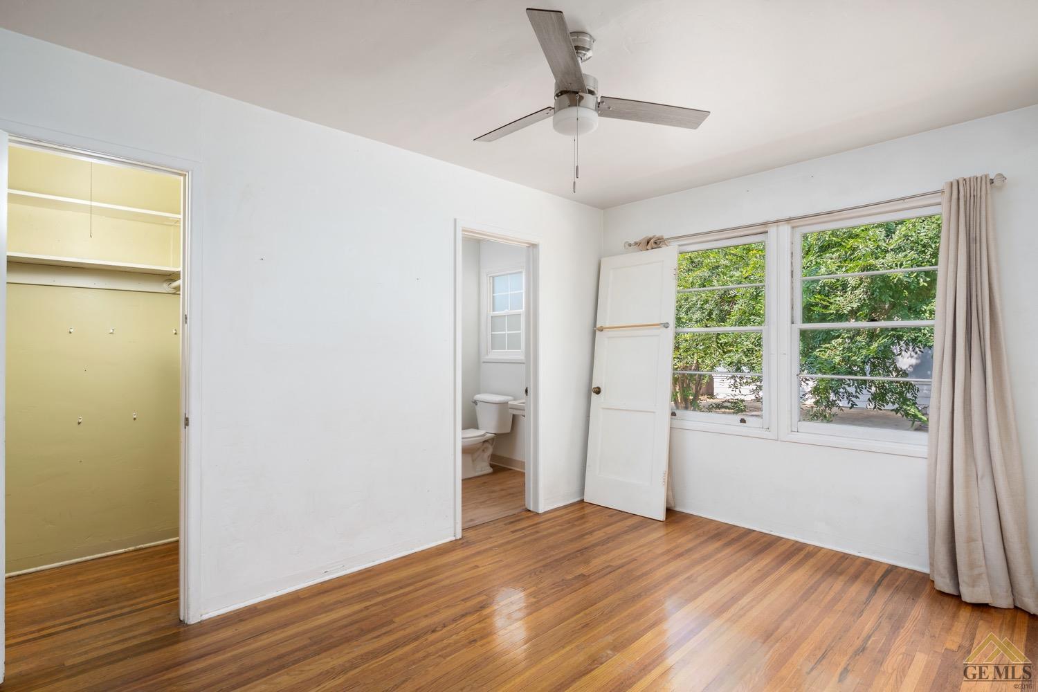 Undisclosed Address Bakersfield, CA 93301 - Photo 14 of 21 a view of an empty room with wooden floor and a window