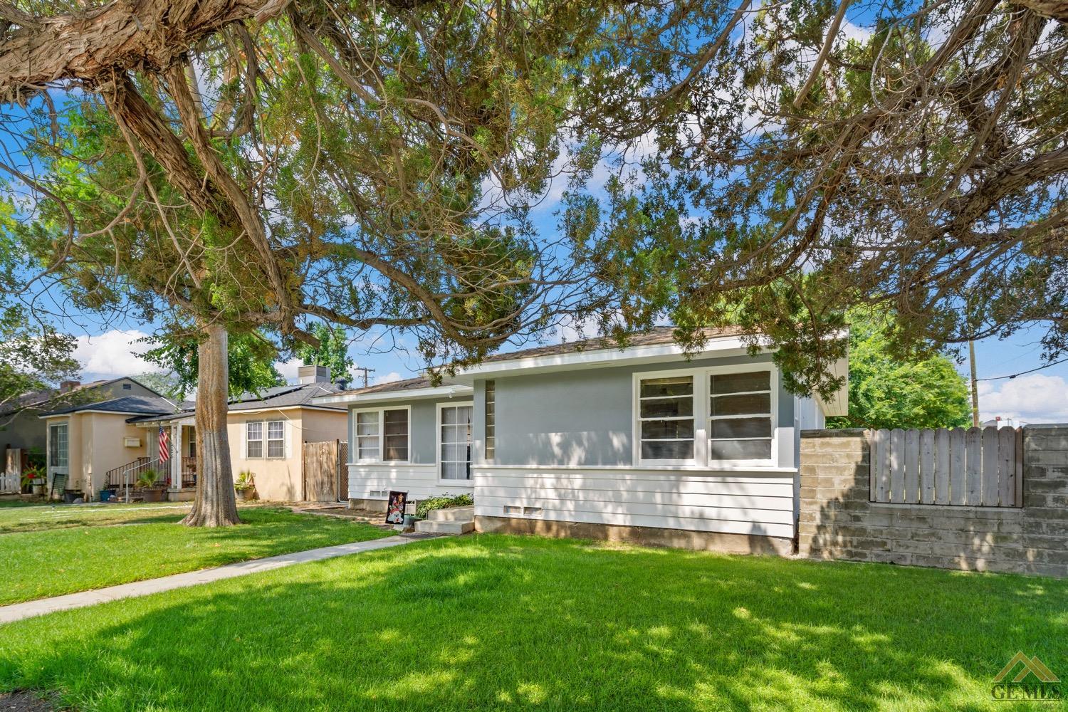 Undisclosed Address Bakersfield, CA 93301 - Photo 3 of 21 a front view of house with yard and green space