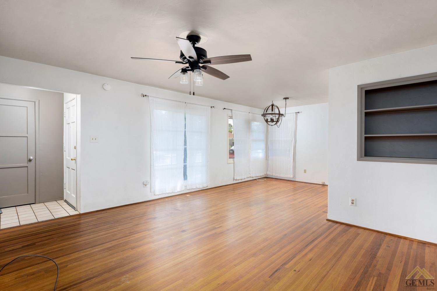 Undisclosed Address Bakersfield, CA 93301 - Photo 5 of 21 a view of empty room with wooden floor and fan