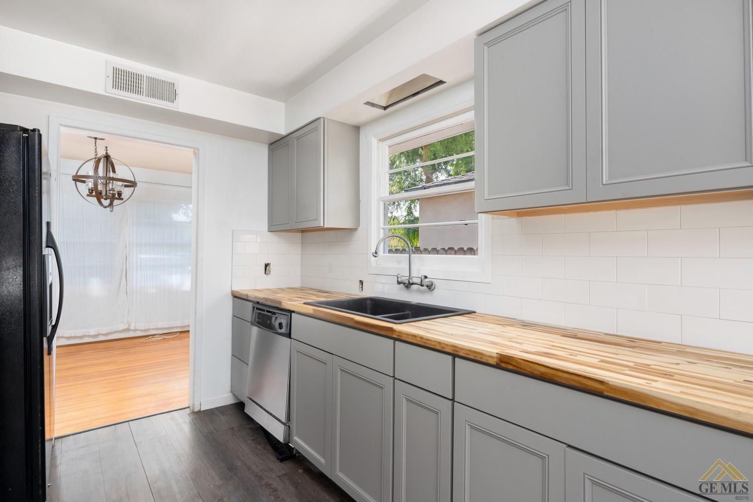 Undisclosed Address Bakersfield, CA 93301 - Photo 7 of 21 a kitchen with a sink cabinets and a window