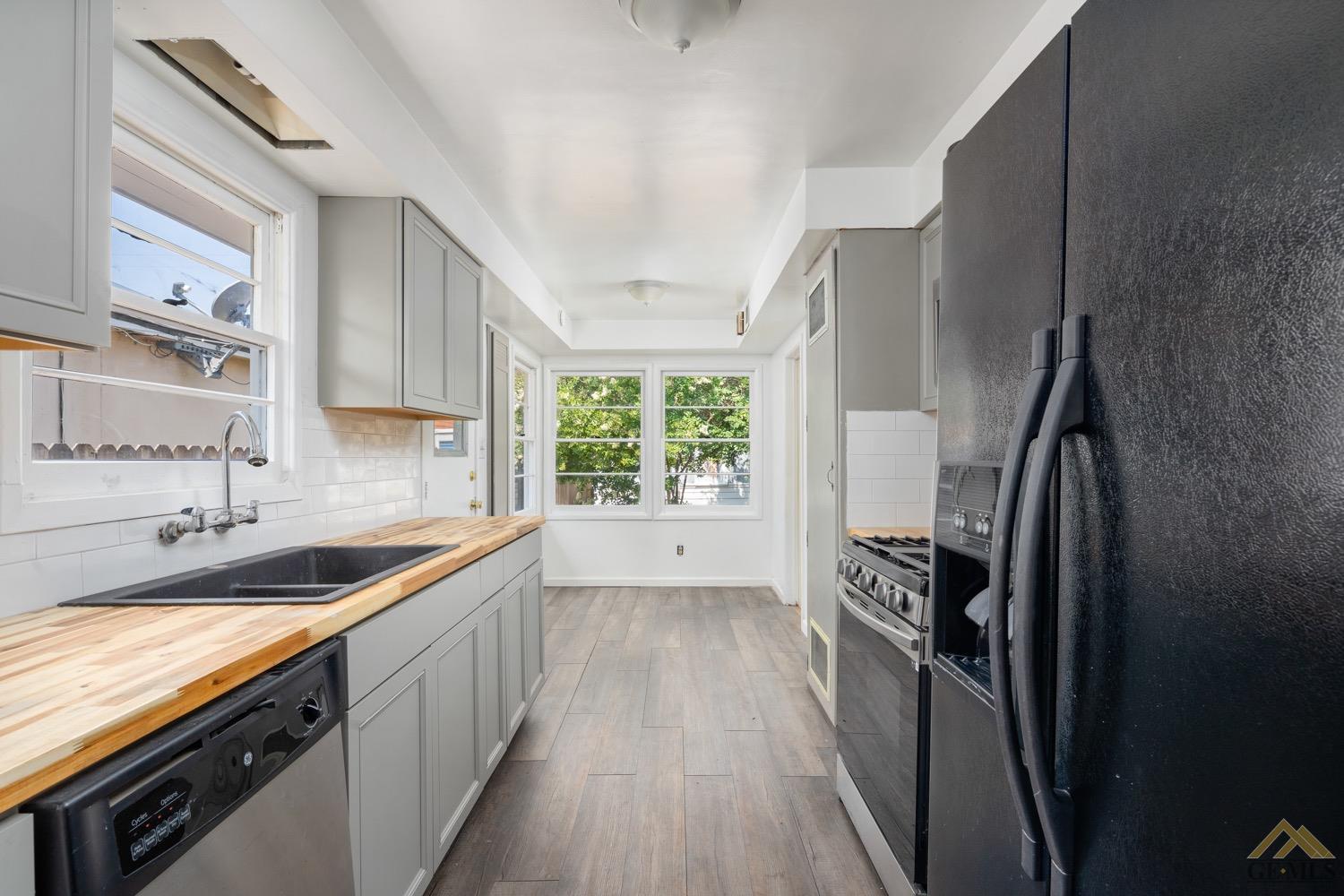 Undisclosed Address Bakersfield, CA 93301 - Photo 8 of 21 a kitchen with a sink a refrigerator and window