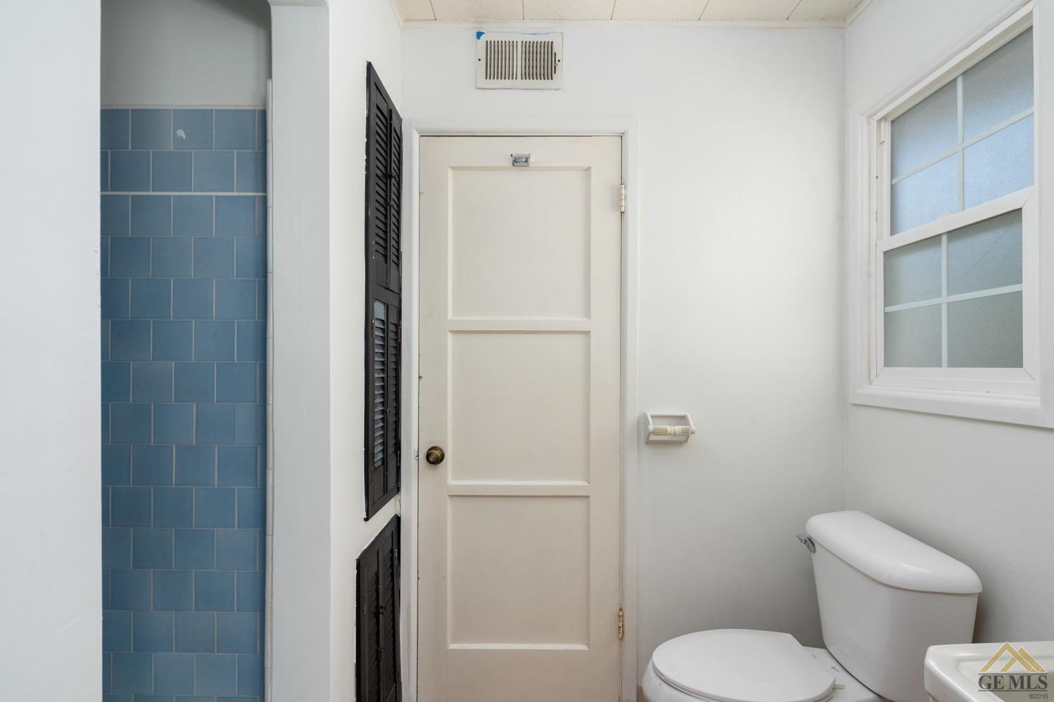 Undisclosed Address Bakersfield, CA 93301 - Photo 10 of 21 a white toilet sitting next to a bathroom sink