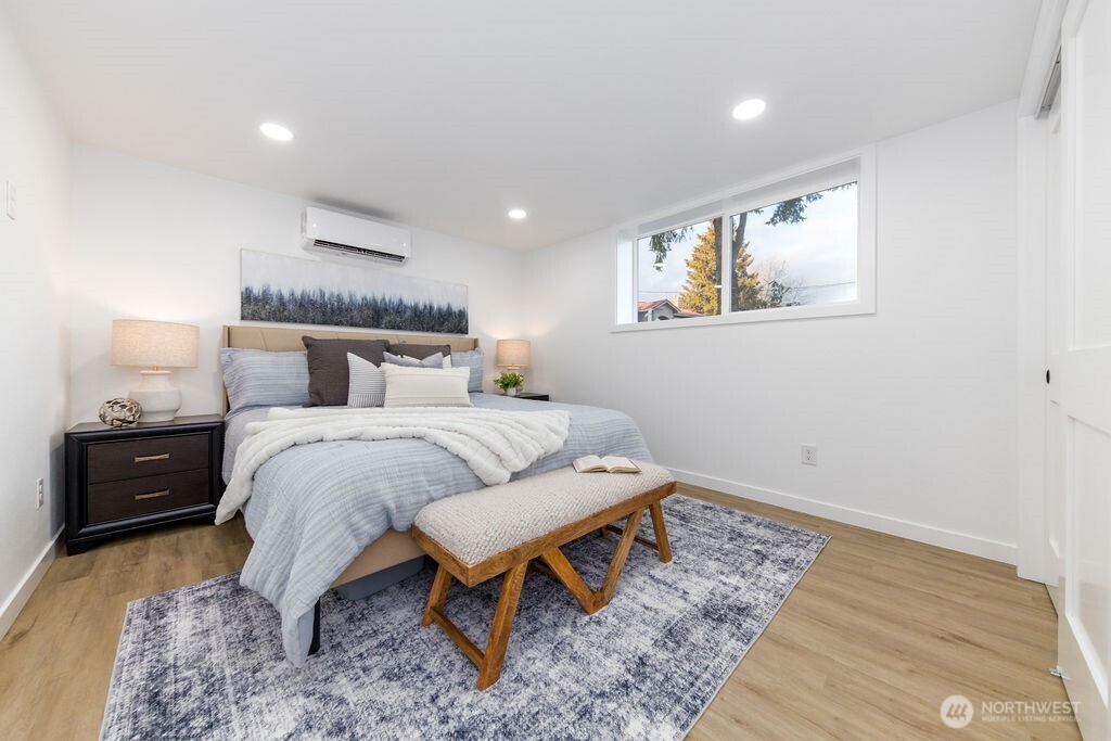 1101 Vashon Court Northeast Renton, WA 98059 - Photo 19 of 30 a bedroom with a bed and wooden floor