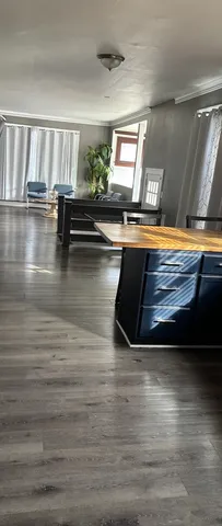 a view of hallway with wooden floor