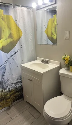 a kitchen with stainless steel appliances wooden floor and a refrigerator