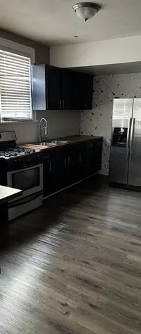 a view of room with window and wooden floor