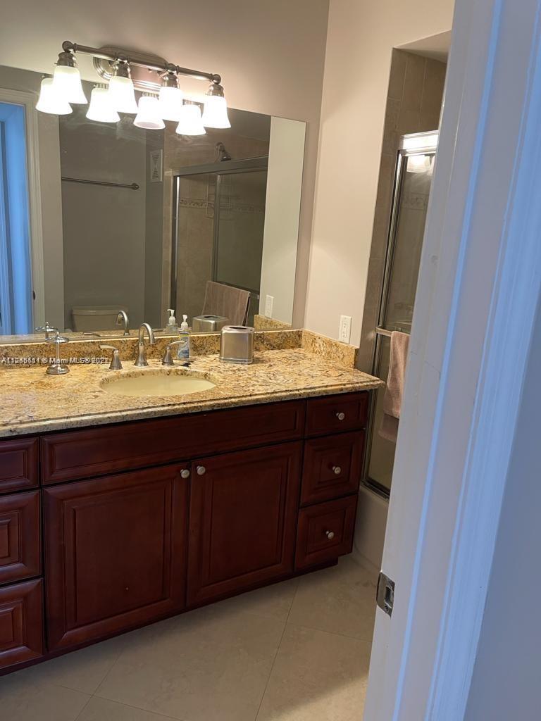 Beach Pompano Beach, FL 33062 - Photo 16 of 17 a bathroom with a double vanity sink and a mirror