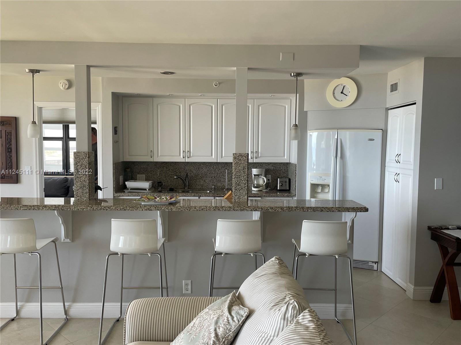 Beach Pompano Beach, FL 33062 - Photo 5 of 17 a kitchen with a refrigerator a stove top oven a sink and dishwasher