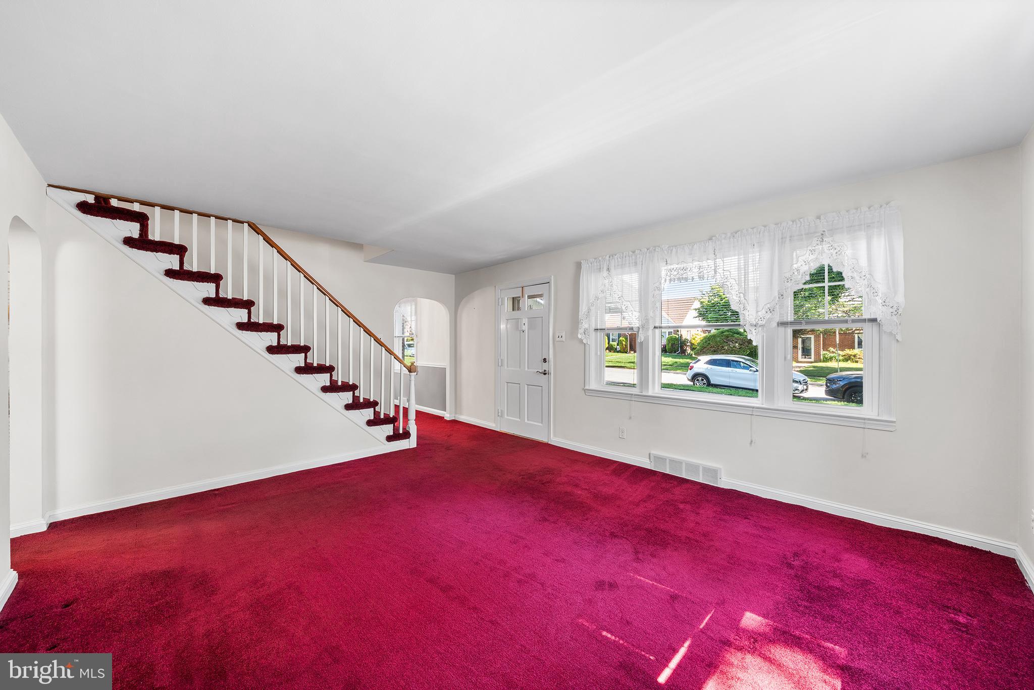 504 Lawrence Road Havertown, PA 19083 - Photo 7 of 20 a view of an empty room with window and stairs