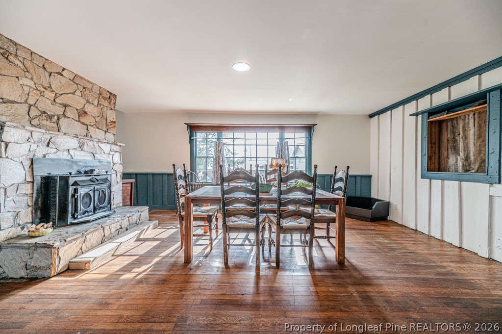 509 Carthage Street Cameron, NC 28326 - Photo 10 of 43 a dining room with furniture a fireplace and wooden floor