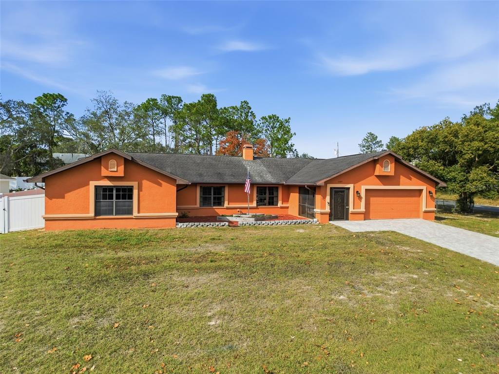4289 Castle Avenue Spring Hill, FL 34609 - Photo 1 of 50 a front view of a house with a yard