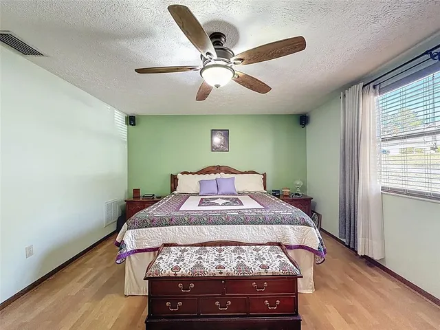 a bed sitting in a bedroom next to a window