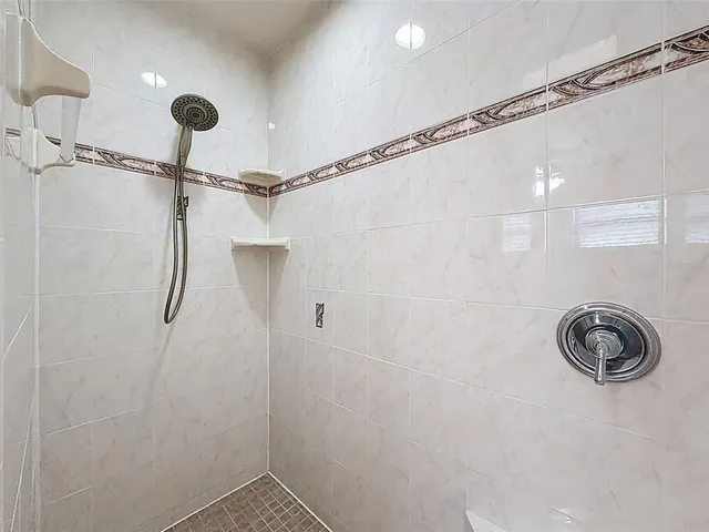 a bathroom with a shower and a sink