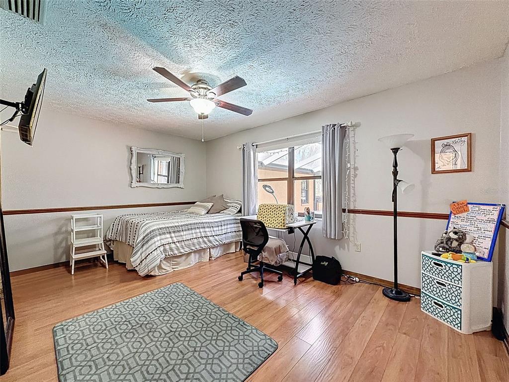 4289 Castle Avenue Spring Hill, FL 34609 - Photo 21 of 50 a bedroom with furniture and a window