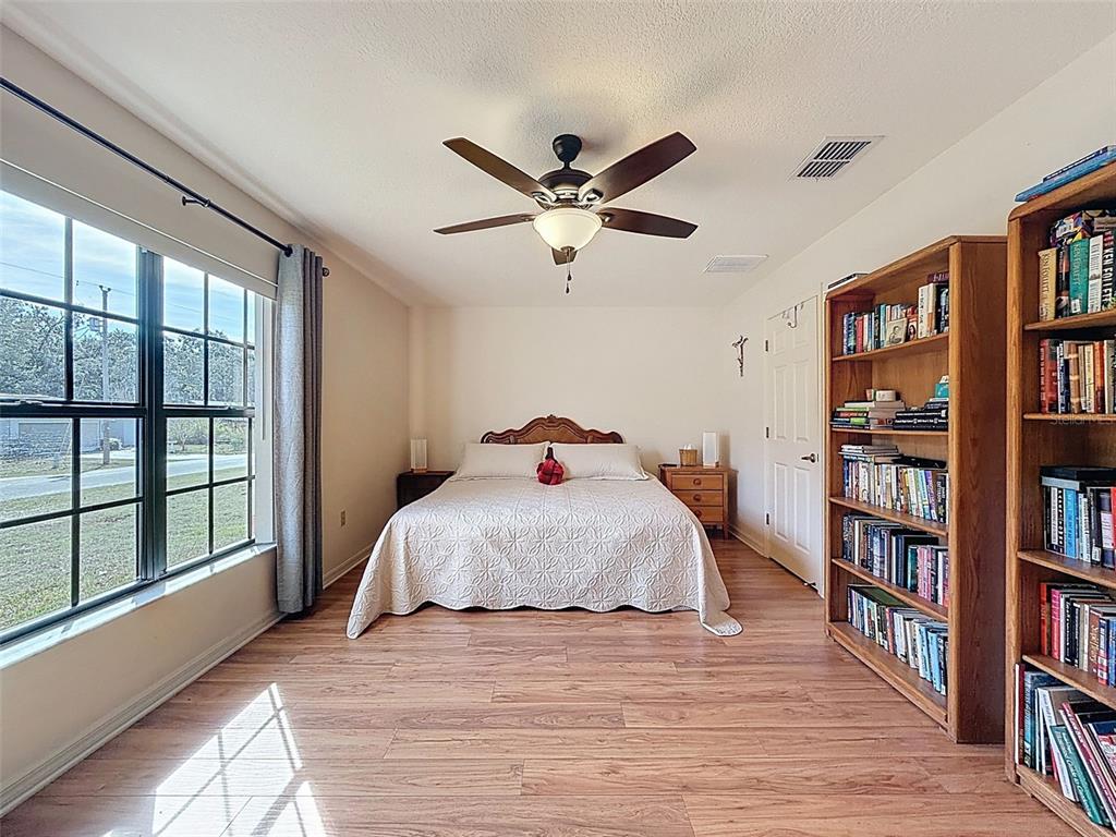4289 Castle Avenue Spring Hill, FL 34609 - Photo 23 of 50 a bedroom with a large bed and a book shelf