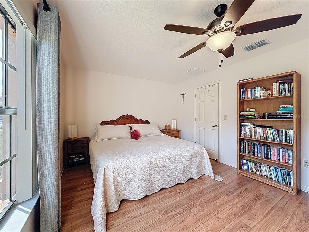 4289 Castle Avenue Spring Hill, FL 34609 - Photo 25 of 50 a bedroom with a bed and a book shelf