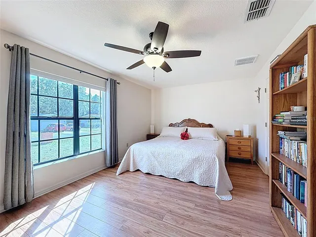 a bedroom with furniture and a book shelf