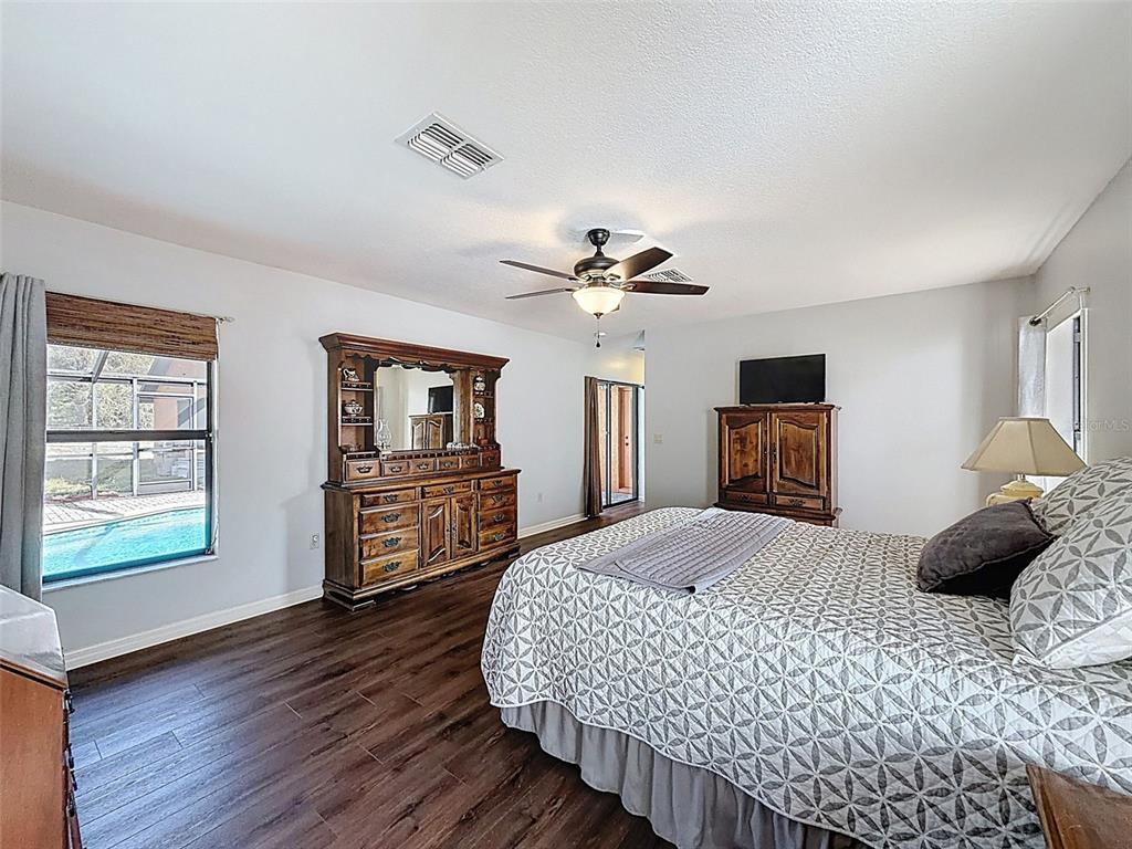 4289 Castle Avenue Spring Hill, FL 34609 - Photo 37 of 50 a bedroom with a bed and wooden floor
