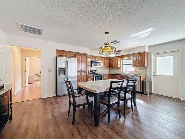a view of a dining room with furniture and wooden floor