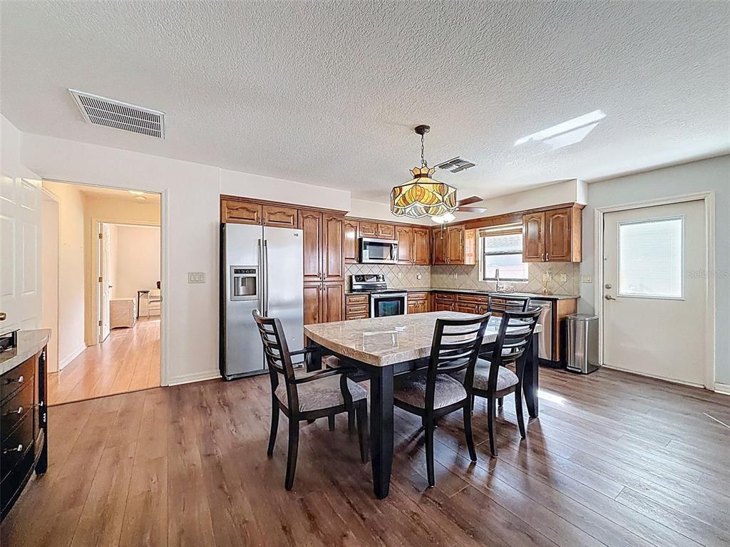 4289 Castle Avenue Spring Hill, FL 34609 - Photo 39 of 50 a view of a dining room with furniture and wooden floor
