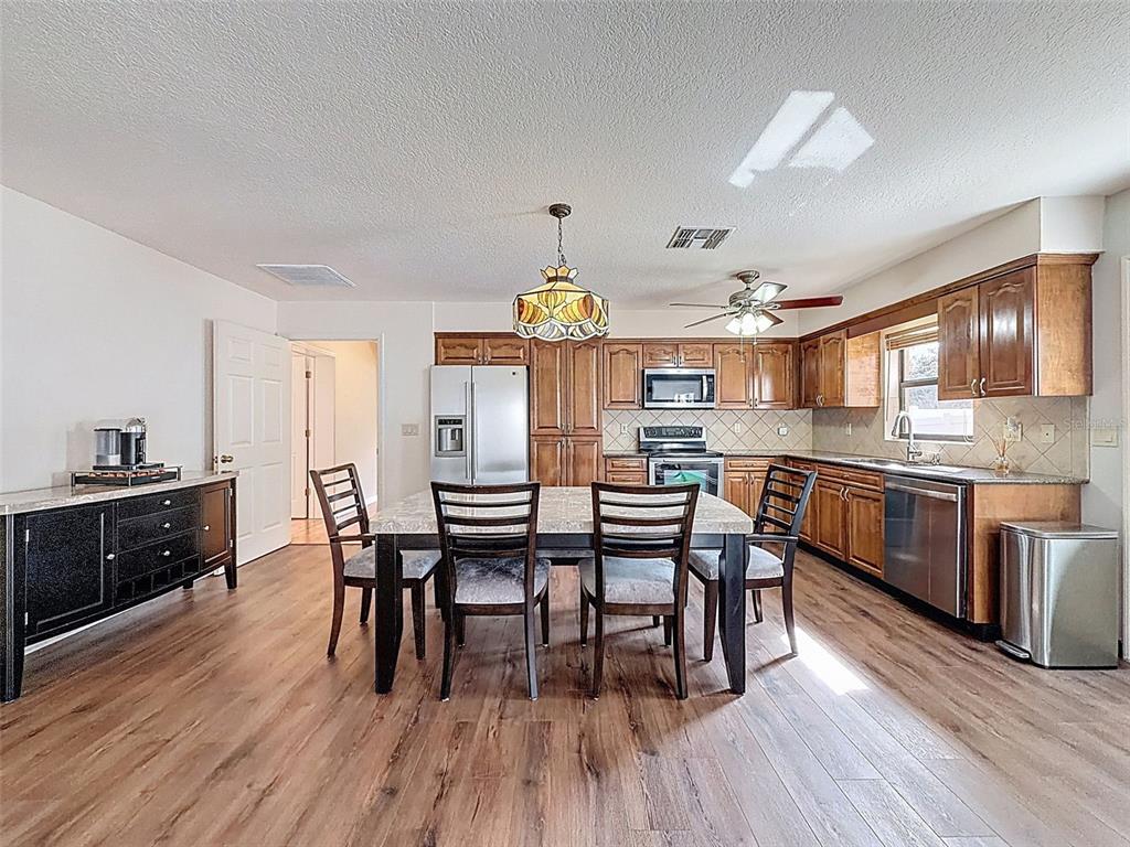 4289 Castle Avenue Spring Hill, FL 34609 - Photo 40 of 50 a view of a dining room with furniture and wooden floor