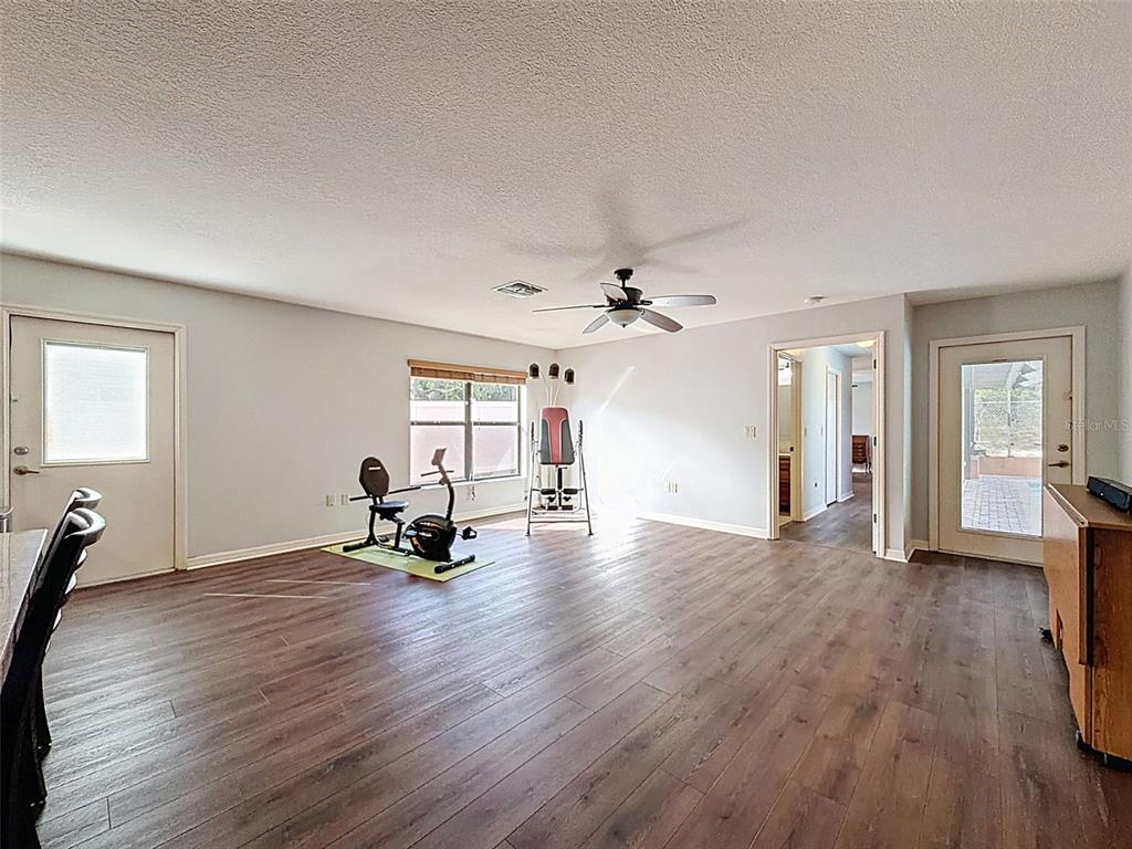 4289 Castle Avenue Spring Hill, FL 34609 - Photo 44 of 50 a living room with furniture and a wooden floor
