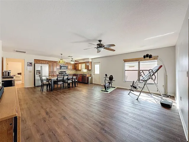 a view of a livingroom with dining room and kitchen view