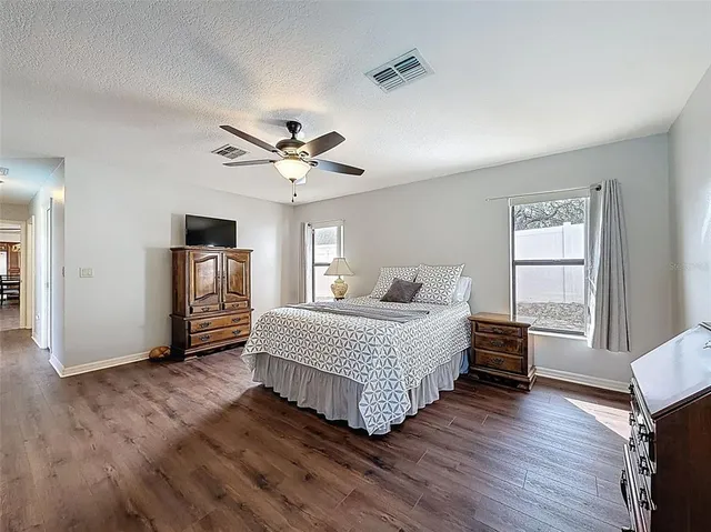 a spacious bedroom with a bed closet and a window